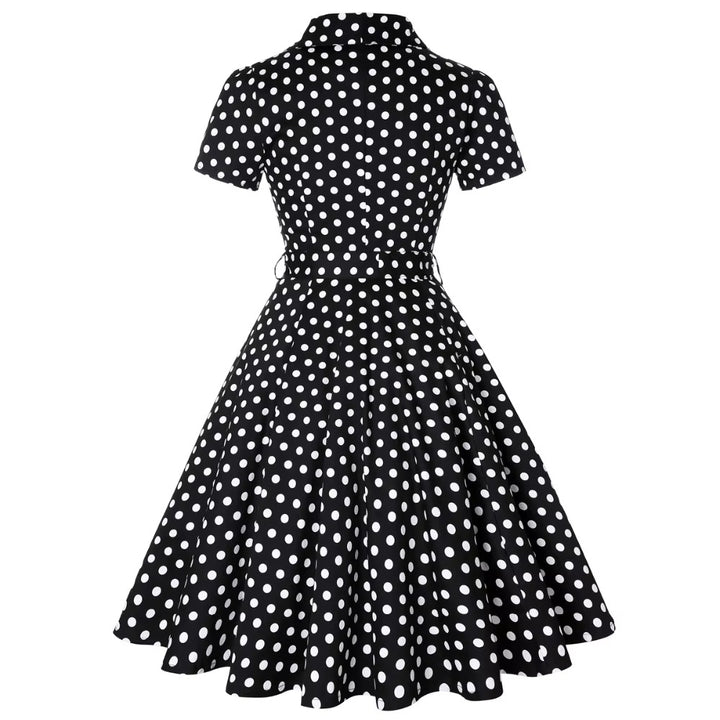 Back view of black polka dot vintage swing dress featuring a classic A-line silhouette and short sleeves.