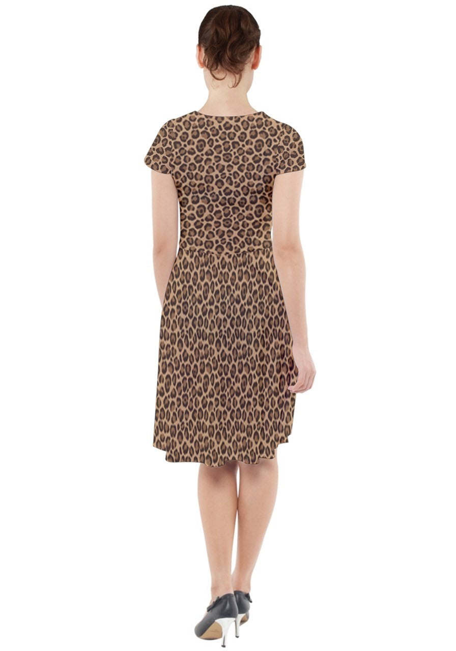 Back view of a leopard cap sleeve midi dress with pockets, showcasing its stylish print and elegant silhouette.