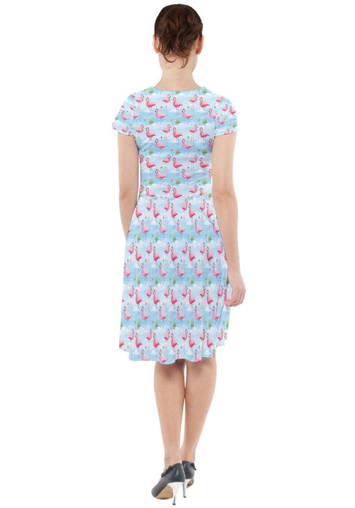 Back view of the Flamingo Dreams cap sleeve midi dress with pockets, featuring a colorful flamingo print on a light blue background.