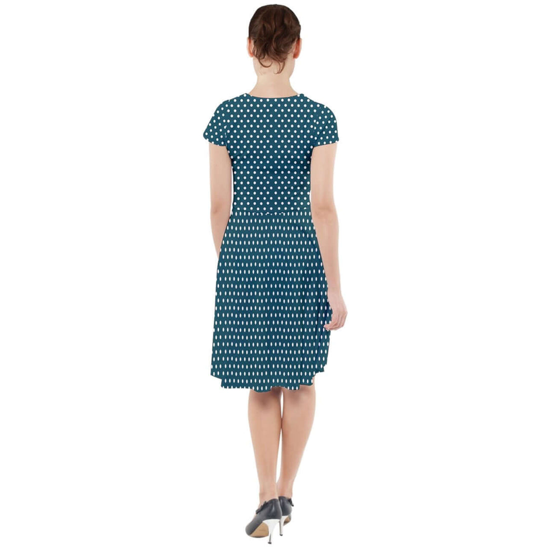 Back view of a teal polka dot cap sleeve midi dress with pockets, featuring playful white polka dots and a flattering fit.