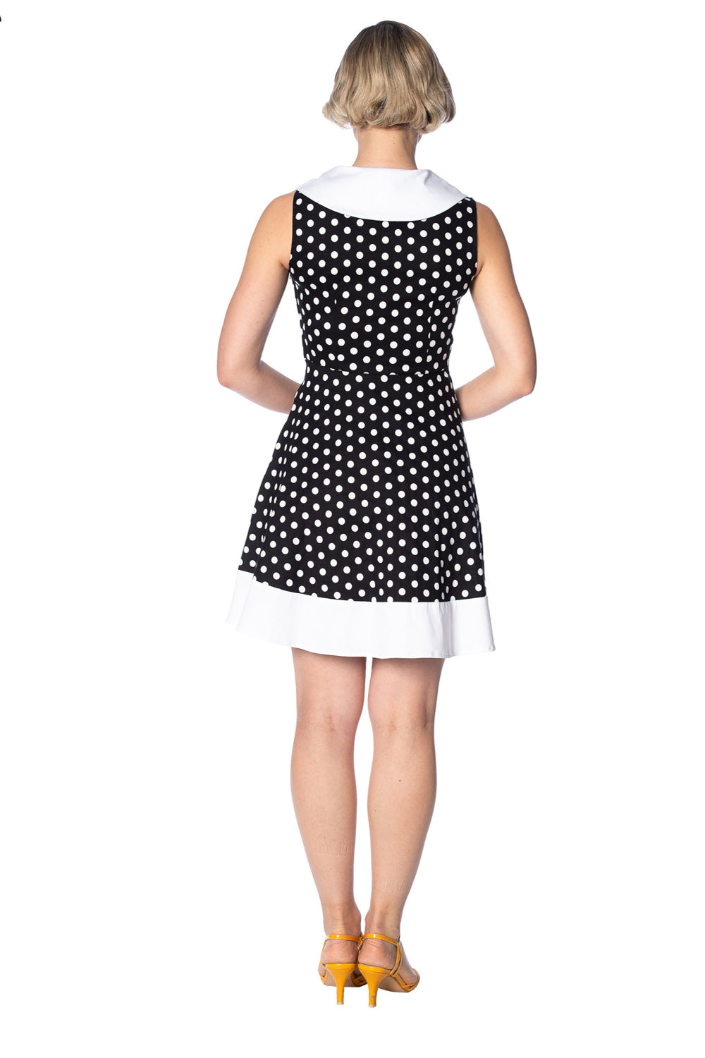 Back view of Banned Retro's Polka Love Cute Dress showcasing polka dots and sailor-style neckline with white hem.