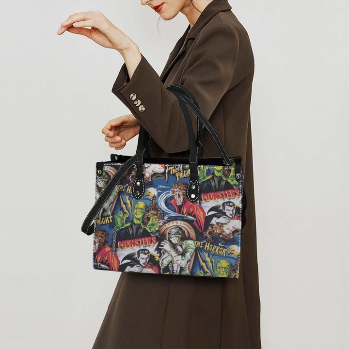 Woman carrying Hollywood Monsters Handbag featuring Dracula, Frankenstein, and Wolfman in a stylish outfit.