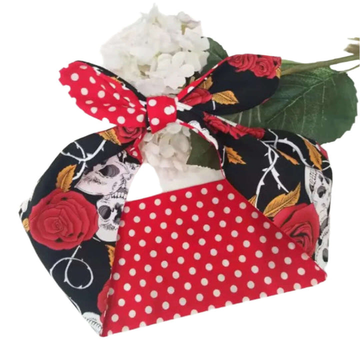 Rockabilly hair tie featuring skull and roses print, red polka dots, perfect for a daring and edgy hairstyle.