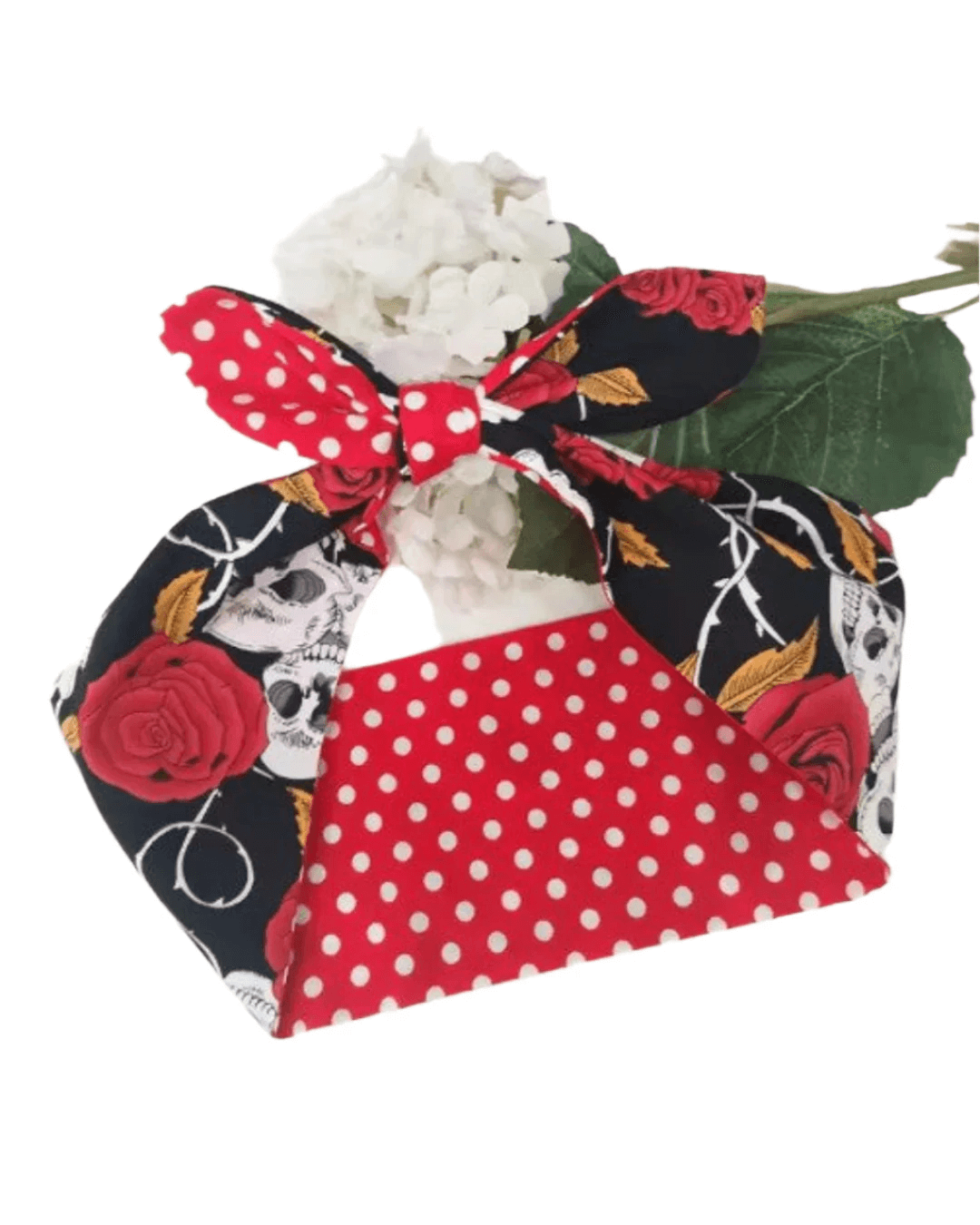 Wired rockabilly hair tie featuring skull and roses print, with polka dot design on the reverse side.