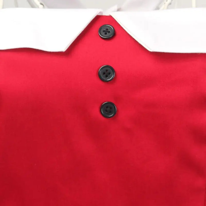 Close-up of a bright red nautical pencil dress featuring a white collar and black buttons, showcasing vintage style.