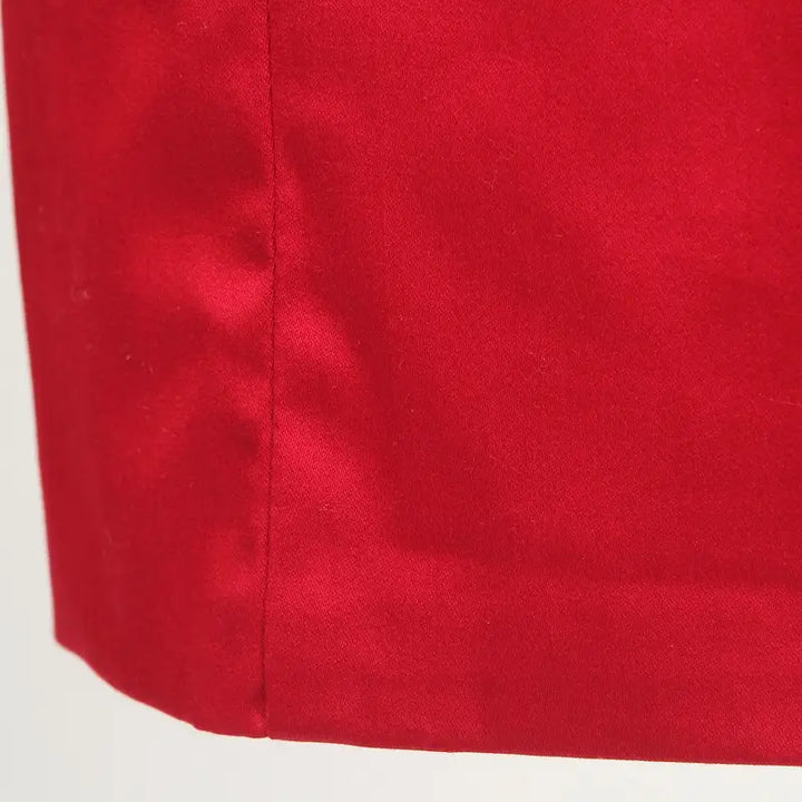 Close-up of the vibrant red fabric of a nautical pencil dress, showcasing smooth texture and seam details.