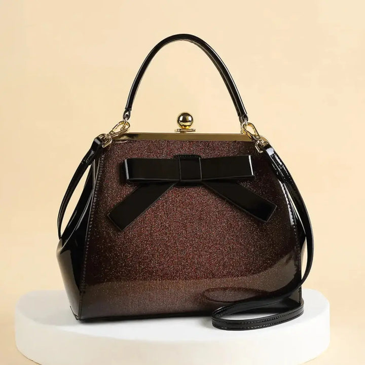 Chocolate Patent Rockabilly Handbag with bow detail, high-shine finish, perfect for retro-inspired outfits.