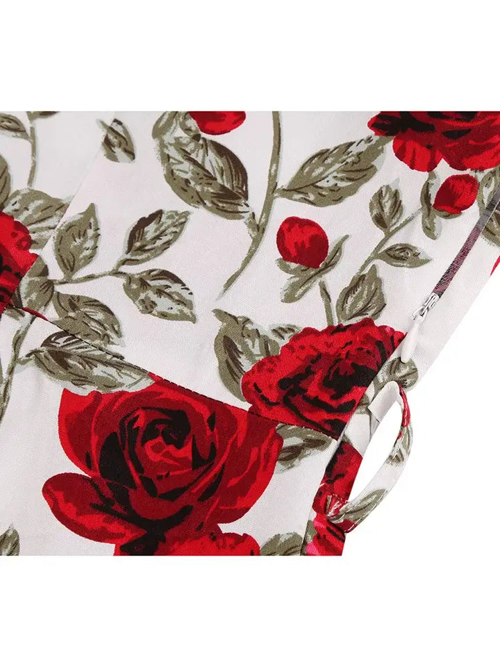 Close-up of the floral print featuring red roses on the Rose Romance Vintage Swing Dress, showcasing elegance and charm.