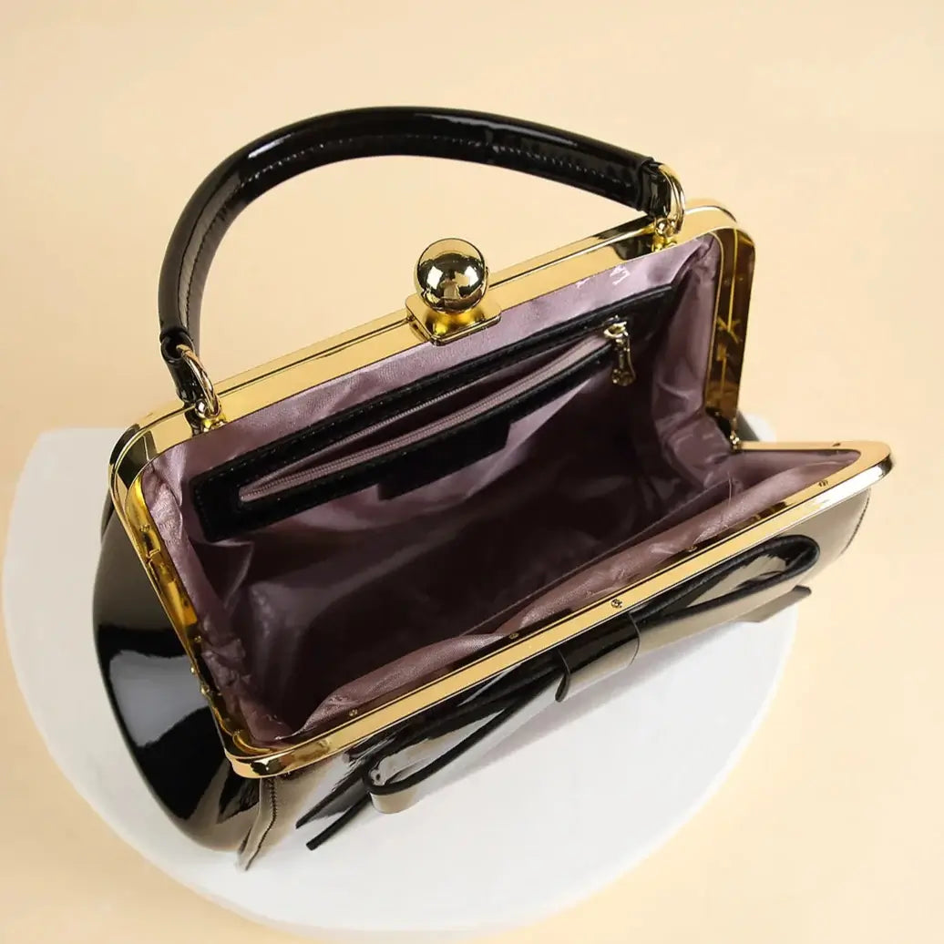 Interior view of Chocolate Patent Rockabilly Handbag showcasing rich lining and Kiss-Lock closure, perfect for vintage fashion.