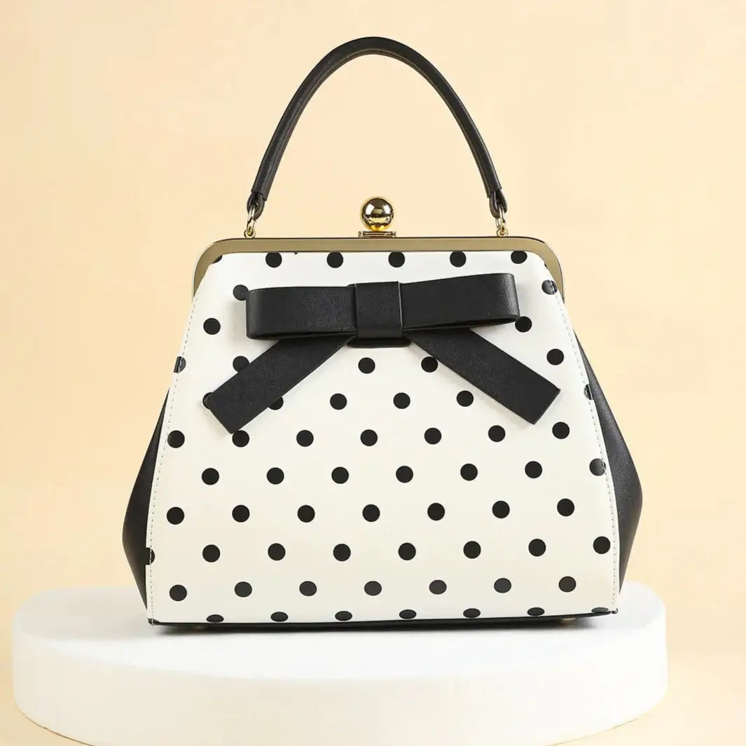 Vintage black polka dot handbag with bow, perfect for rockabilly and retro style outfits.