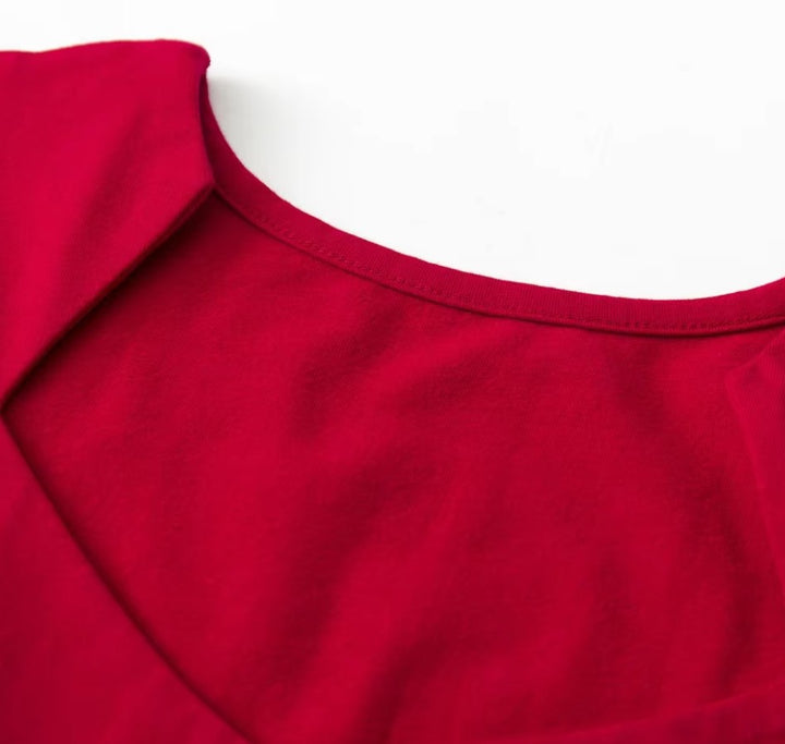 Close-up of the neckline of the Bridget retro top in vibrant red, showcasing its stylish design and soft fabric.