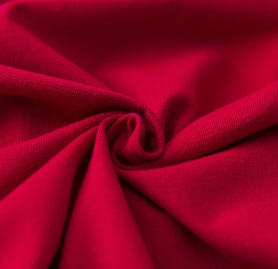 Close-up of soft, vibrant red fabric showcasing the texture for the Bridget retro top.