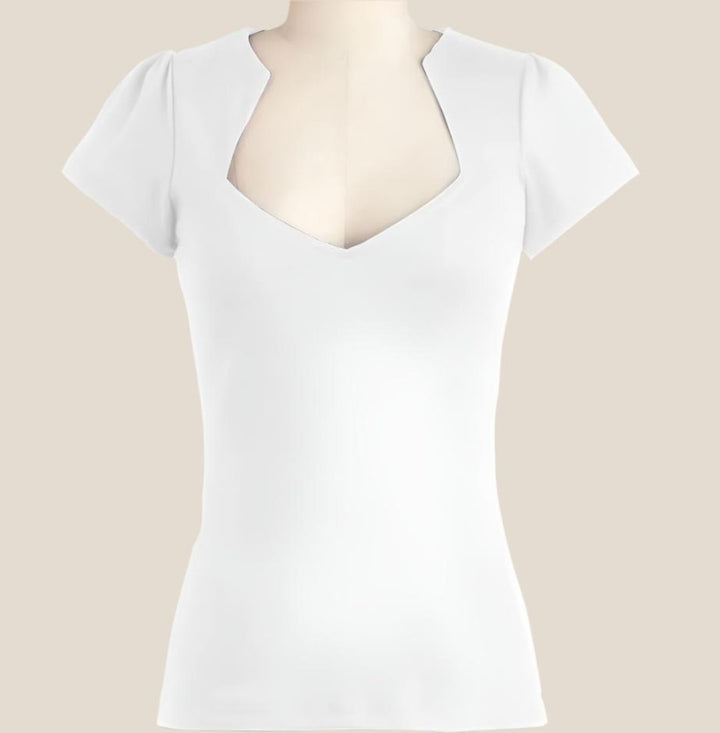 Bridget retro top in classic white with short puff sleeves and a flattering V-neck design. A versatile wardrobe staple.