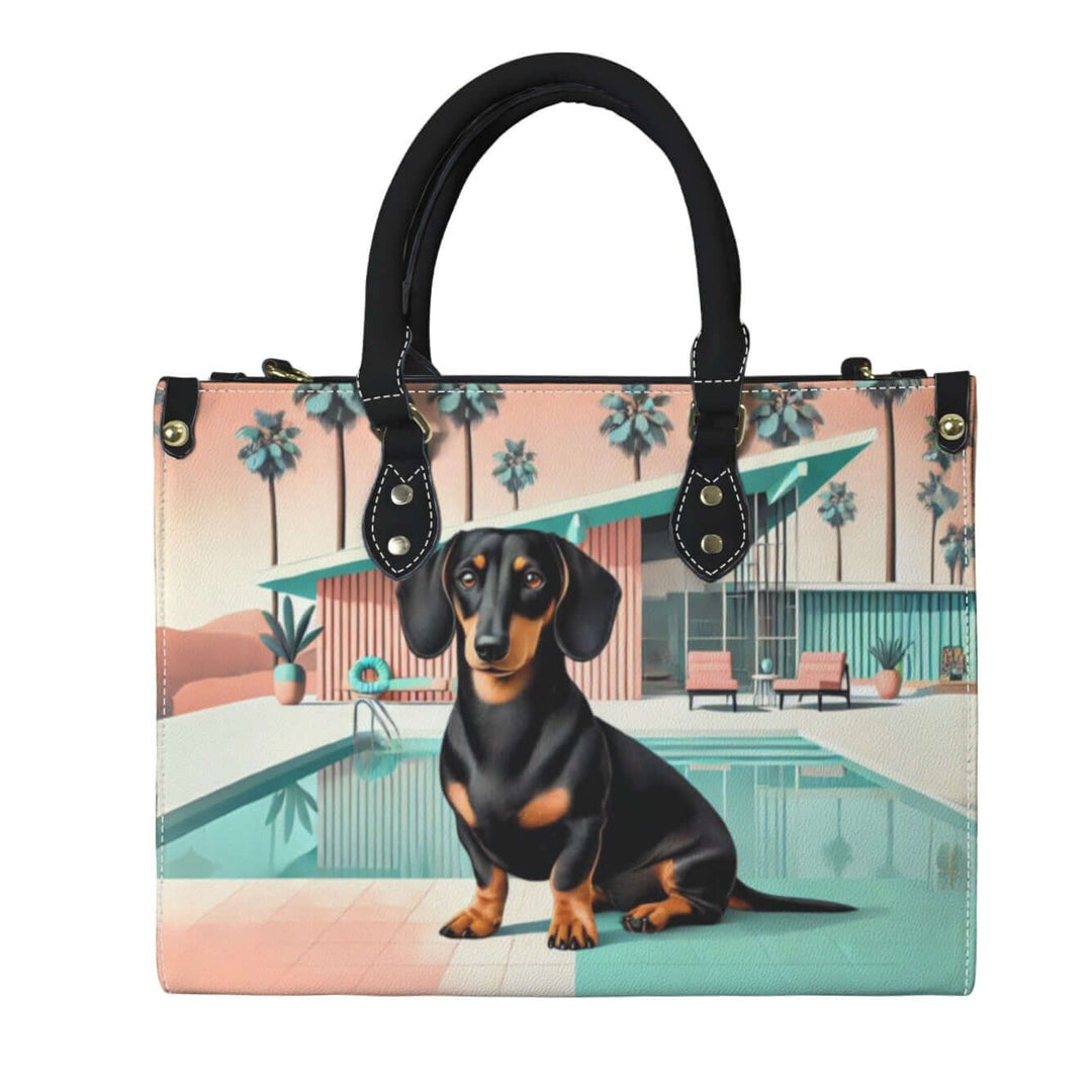 Palm Springs Dachshund handbag featuring a black and tan dachshund design with a retro poolside backdrop.