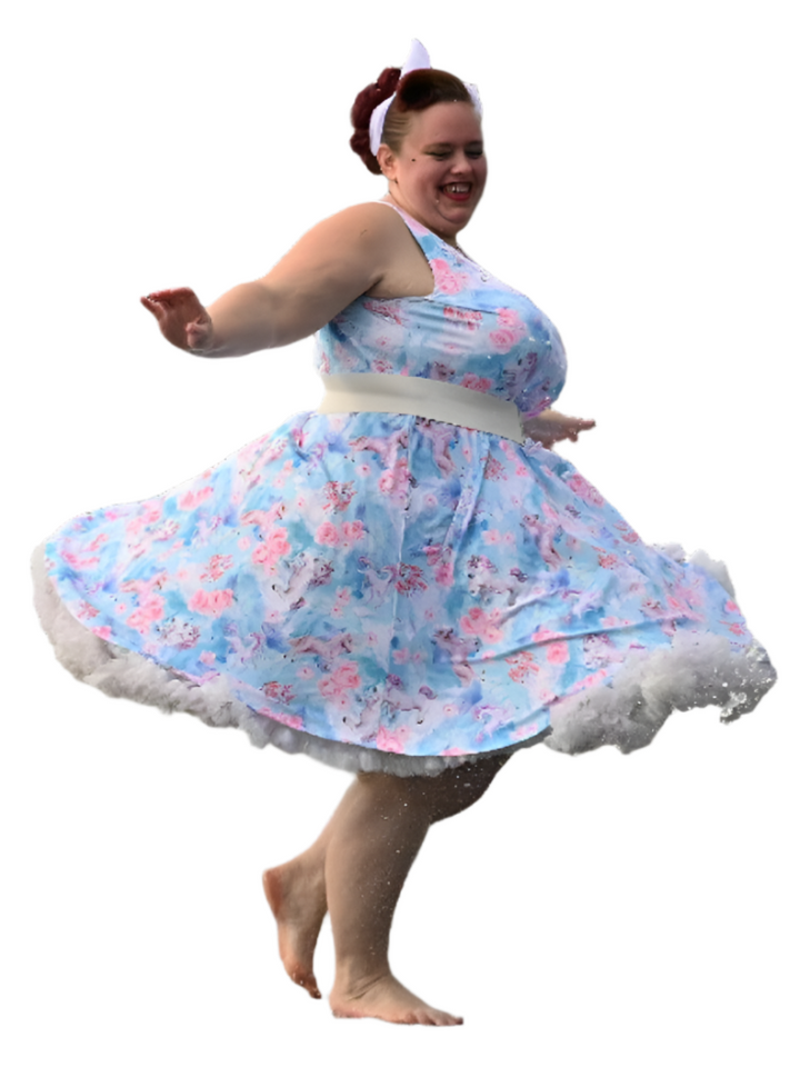 Woman twirling in a whimsical blue and pink floral skater dress with a flared skirt and petticoat, exuding joy.