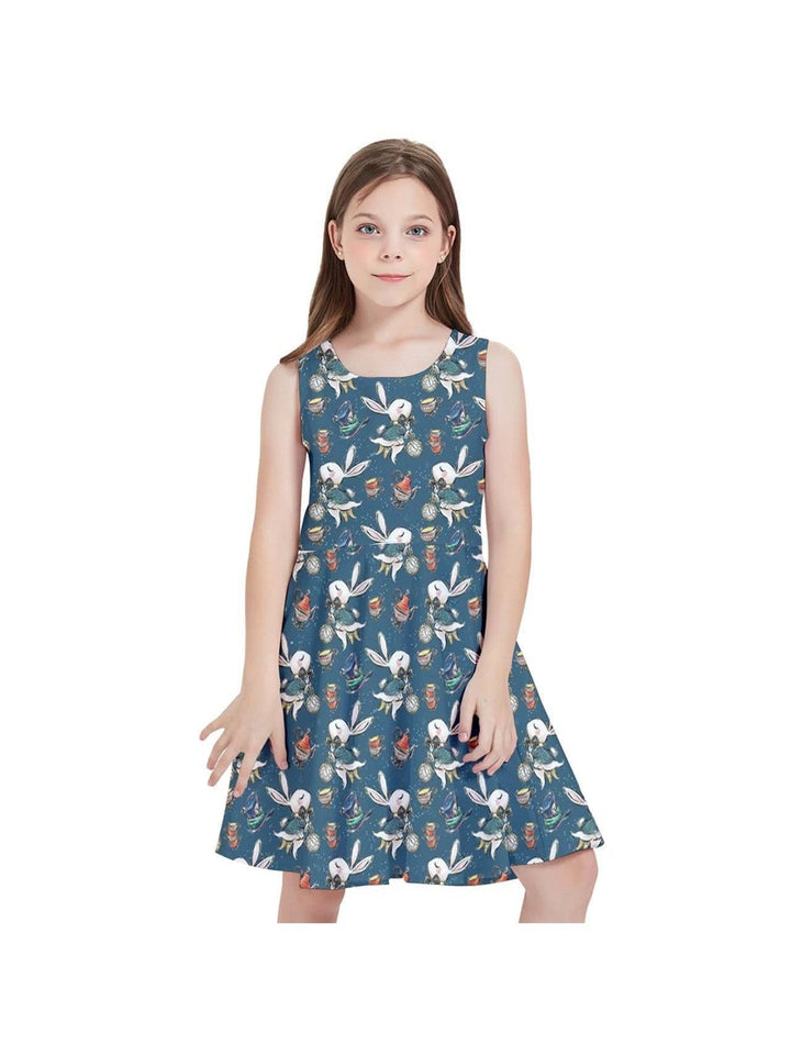 Young girl wearing Down the Rabbit Hole Kids' Skater Dress featuring whimsical Alice in Wonderland design on a vibrant blue background.