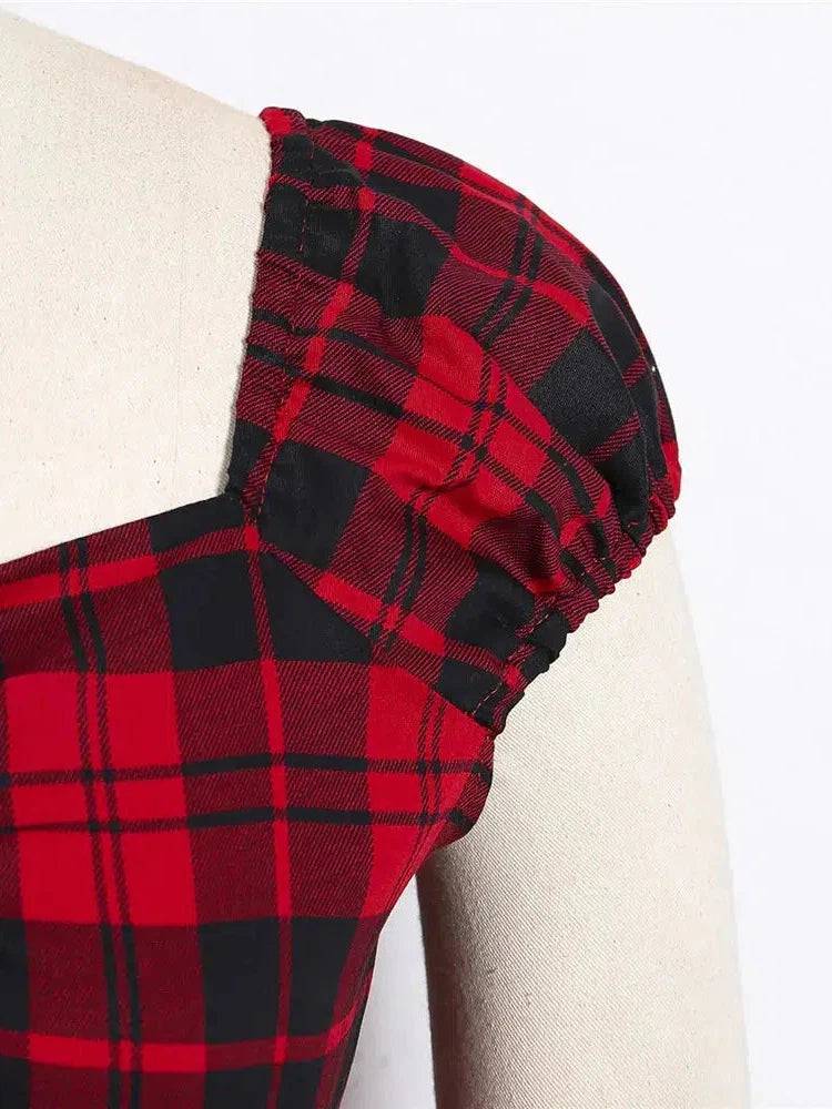 Close-up of the puff sleeve and bold red plaid pattern on a retro top, showcasing vintage charm and edgy style.