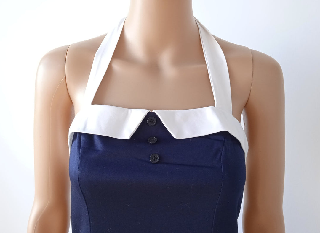 Navy nautical pencil dress with a halter neck and white collar, showcasing vintage elegance and charming style.